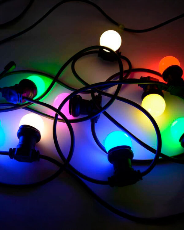 Farverige LED-lyspærer i blå, grøn, gul, rød og hvid skaber en stemningsfuld belysning. Perfekt til udendørs brug, fester og hyggelige omgivelser med varm atmosfære.