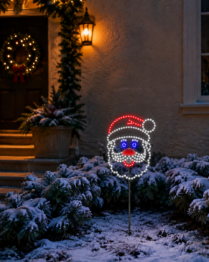 LED julemandsansigt på jordspyd i haven